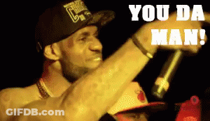 A Man In A Chicago Bulls Hat Is Holding A Microphone And Says You Da Man GIF