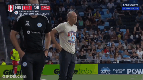 A Man In A Chicago Cubs Shirt Stands On The Field GIF