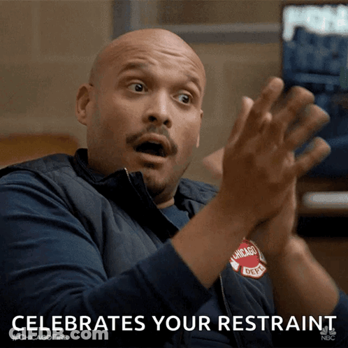 A Man In A Chicago Fire Dept Vest Is Clapping His Hands GIF