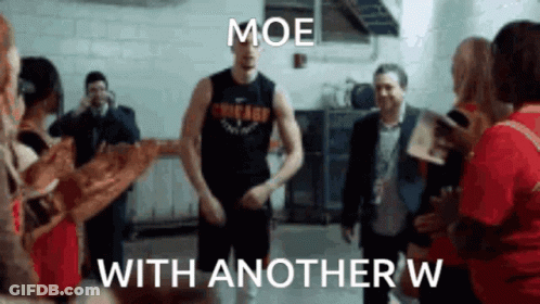 A Man In A Chicago Jersey Is Dancing In Front Of A Group Of People . GIF