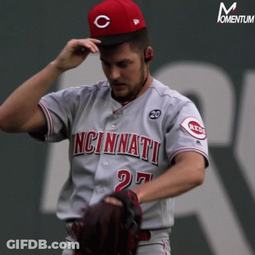 A Man In A Cincinnati Jersey Adjusts His Hat GIF