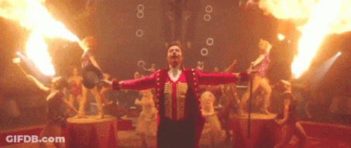 A Man In A Circus Costume Is Surrounded By Flames And Bubbles GIF