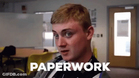 A Man In A Classroom With The Word Paperwork Written Above Him GIF