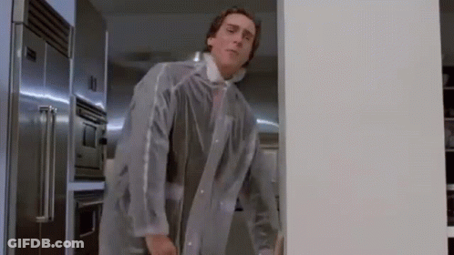 A Man In A Clear Coat Is Standing In A Kitchen . GIF