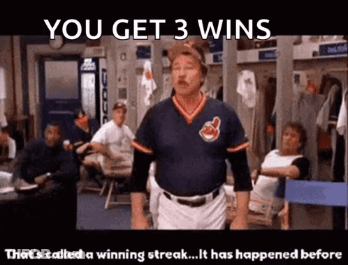 A Man In A Cleveland Indians Jersey Is Standing In A Locker Room GIF