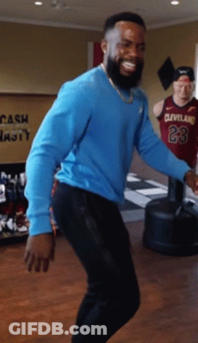 A Man In A Cleveland Jersey Is Dancing In A Room GIF