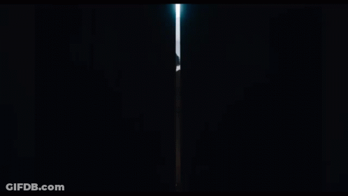 A Man In A Cloak Is Standing In A Dark Tunnel GIF