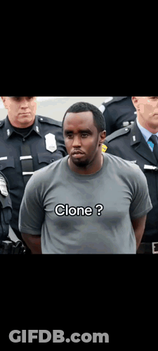 A Man In A Clone T-Shirt Is Standing In Front Of A Group Of Police Officers GIF
