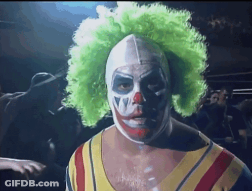 A Man In A Clown Costume Has A Green Wig On GIF