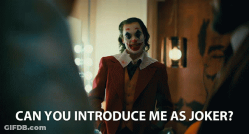A Man In A Clown Costume Is Standing In A Room With The Words " Can You Introduce Me As Joker " Below Him GIF