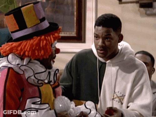 A Man In A Clown Costume Is Talking To Another Man GIF