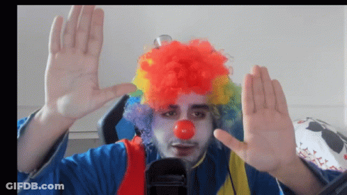 A Man In A Clown Costume With A Red Nose GIF