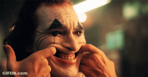 A Man In A Clown Mask Is Making A Funny Face GIF