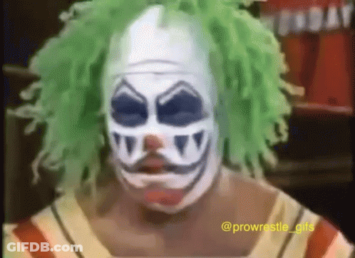 A Man In A Clown Mask With Green Hair GIF