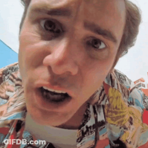 A Man In A Colorful Shirt Is Making A Face GIF