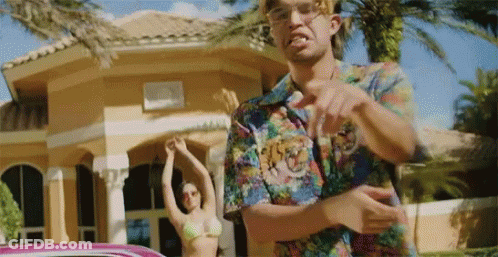A Man In A Colorful Shirt Is Pointing At A Woman In A Bikini . GIF