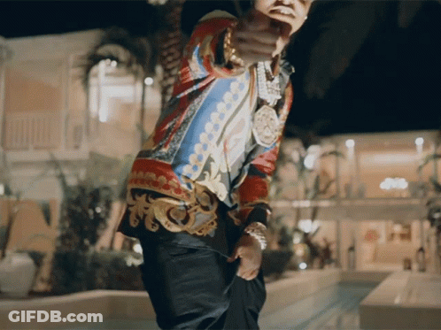 A Man In A Colorful Shirt Is Pointing His Finger At The Camera GIF