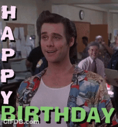 A Man In A Colorful Shirt Is Smiling With The Words Happy Birthday Behind Him GIF