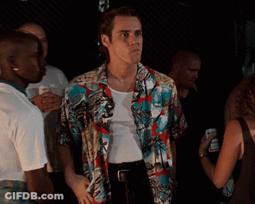 A Man In A Colorful Shirt Is Standing In A Crowd Of People GIF