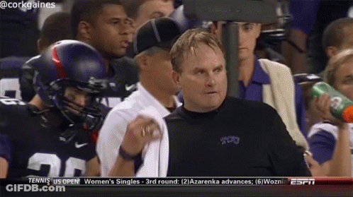 A Man In A Cork Gaines Jersey Watches A Football Game On Espn GIF