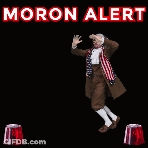 A Man In A Costume Is Dancing In Front Of A Sign That Says " Moron Alert " GIF
