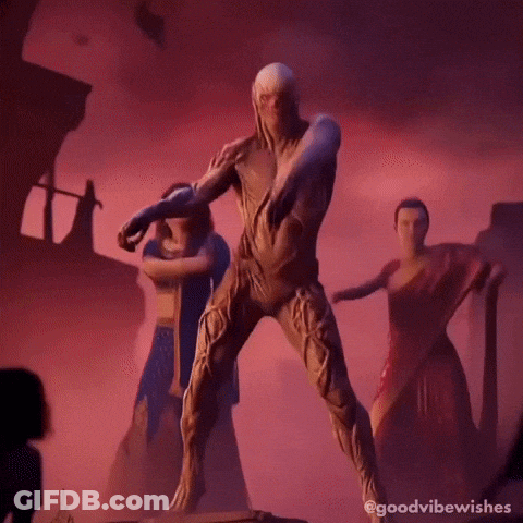 A Man In A Costume Is Dancing With A Group Of Women In Saris . GIF