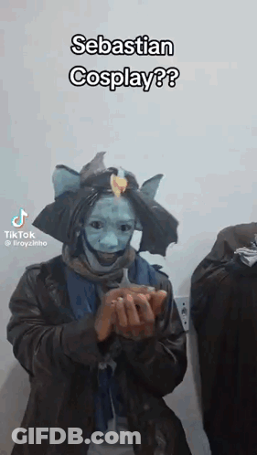A Man In A Costume Is Holding Something In His Hands And Says Sebastian Cosplay . GIF
