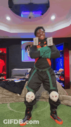 A Man In A Costume Is Standing In A Bedroom Holding A Sword . GIF