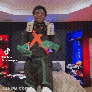 A Man In A Costume Is Standing In Front Of A Bed With A Tiktok Logo On The Bottom Right GIF