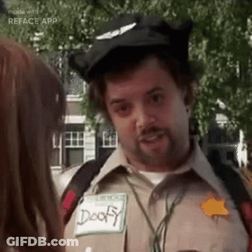 A Man In A Costume Is Talking To A Woman In A Park . GIF