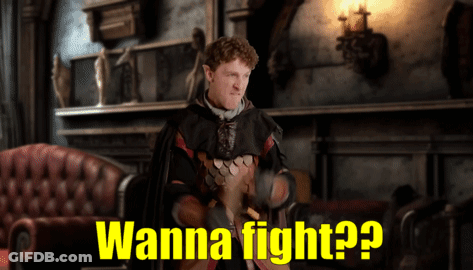 A Man In A Costume Says " Wanna Fight " In A Room GIF