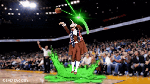 A Man In A Costume Throws A Basketball In A Stadium GIF