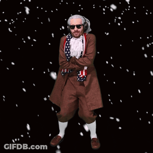 A Man In A Costume With An American Flag Around His Neck Is Standing In The Snow GIF