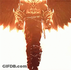 A Man In A Costume With Chains Around His Waist Is Standing In Front Of Flames . GIF