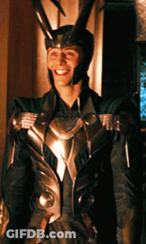 A Man In A Costume With Horns On His Head Is Smiling GIF