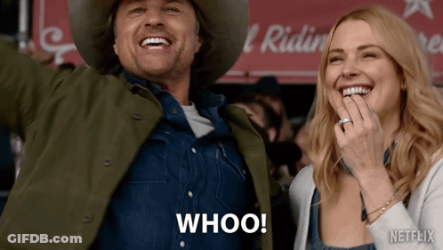 A Man In A Cowboy Hat And A Woman In Overalls Are Laughing And The Man Is Saying Whoo! GIF