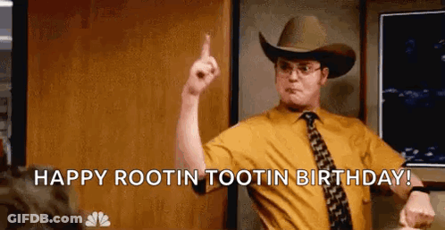 A Man In A Cowboy Hat And Tie Is Pointing Up . GIF