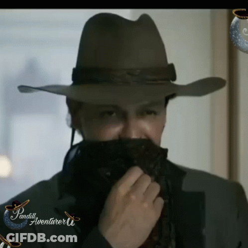 A Man In A Cowboy Hat Is Covering His Face With A Bandana And The Words Pandill Aventurar U. On The Bottom GIF