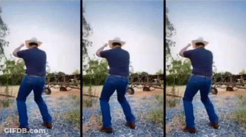 A Man In A Cowboy Hat Is Dancing In A Dirt Field GIF