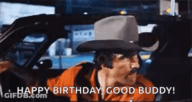 A Man In A Cowboy Hat Is Driving A Car And Saying `` Happy Birthday , Good Buddy '' . GIF