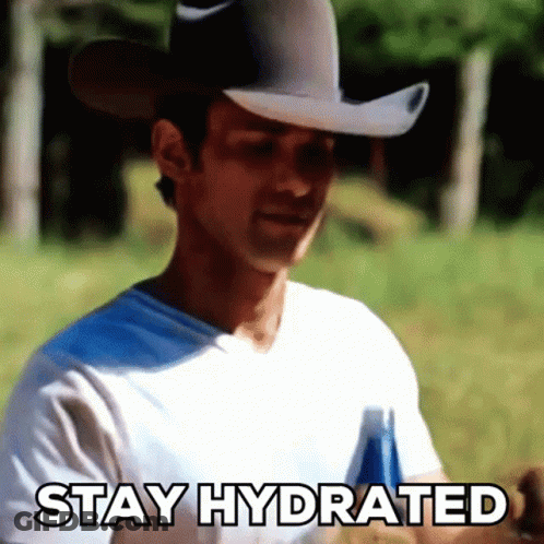 A Man In A Cowboy Hat Is Holding A Bottle Of Beer And Says Stay Hydrated GIF