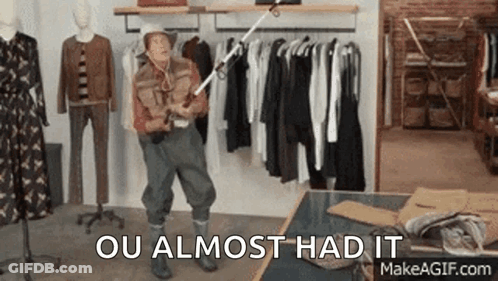 A Man In A Cowboy Hat Is Holding A Fishing Rod In A Clothing Store And Says Ou Almost Had It . GIF