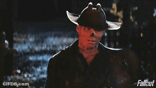 A Man In A Cowboy Hat Is Holding A Rifle With Fallout Written On The Bottom Right GIF