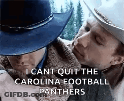 A Man In A Cowboy Hat Is Hugging Another Man In A Fur Coat . GIF