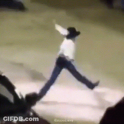 A Man In A Cowboy Hat Is Jumping In The Air While Wearing Jeans And A White Shirt . GIF