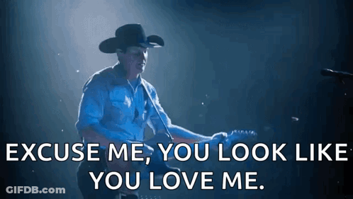 A Man In A Cowboy Hat Is Playing A Guitar And Says Excuse Me You Look Like You Love Me . GIF