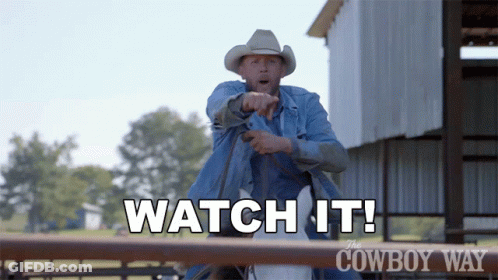 A Man In A Cowboy Hat Is Pointing At Something With The Words " Watch It " Above Him GIF