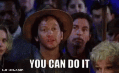 A Man In A Cowboy Hat Is Sitting In A Crowd Of People With The Words `` You Can Do It '' Written On His Face . GIF