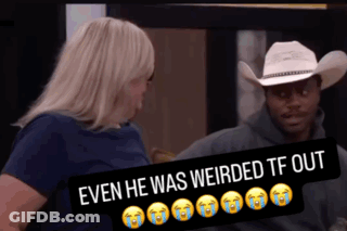 A Man In A Cowboy Hat Is Sitting Next To A Woman With A Sign That Says Even He Was Weirded Out GIF