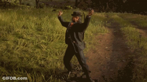 A Man In A Cowboy Hat Is Standing In A Field GIF